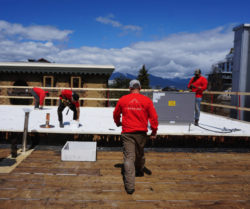 Image of Canuck Roofers walking on commercial roof
