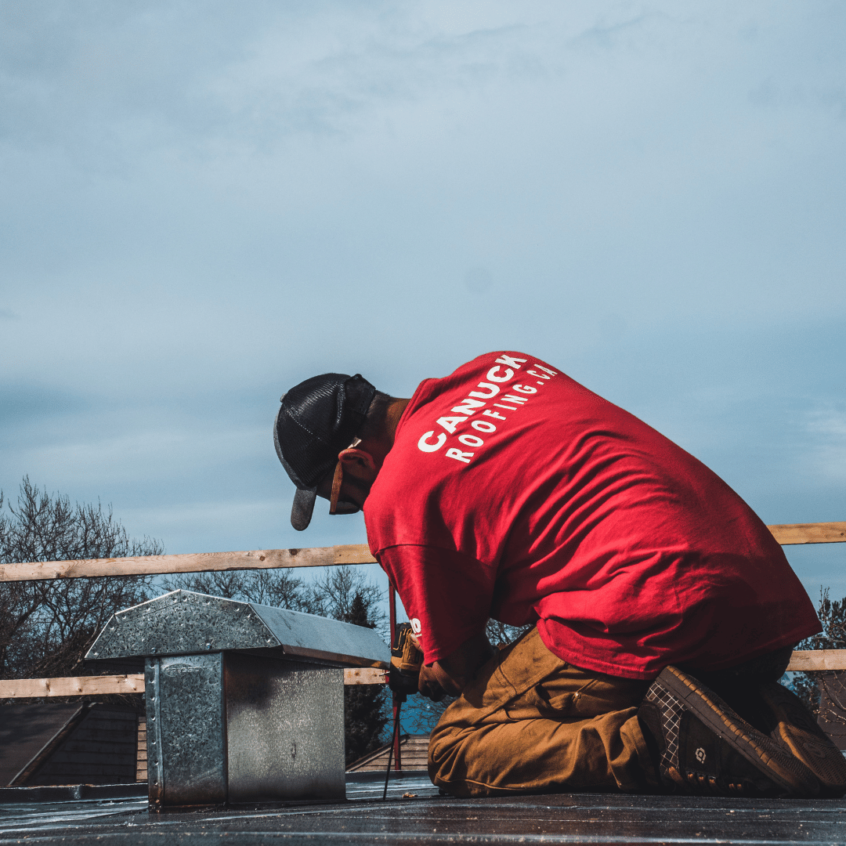 Image of Canuck Roofing roofer working on commercial roof