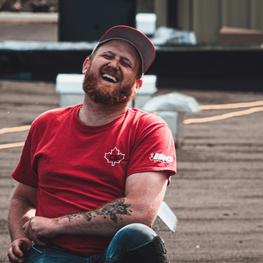 Image of Canuck Roofing roofer smiling on the job