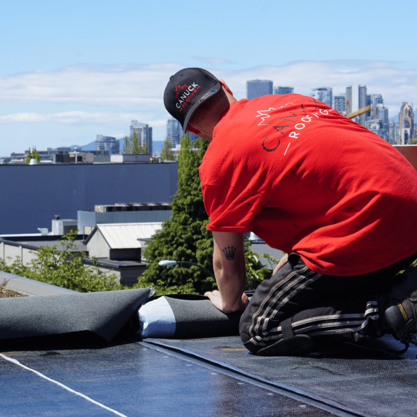 Image of roofer working on flat roof